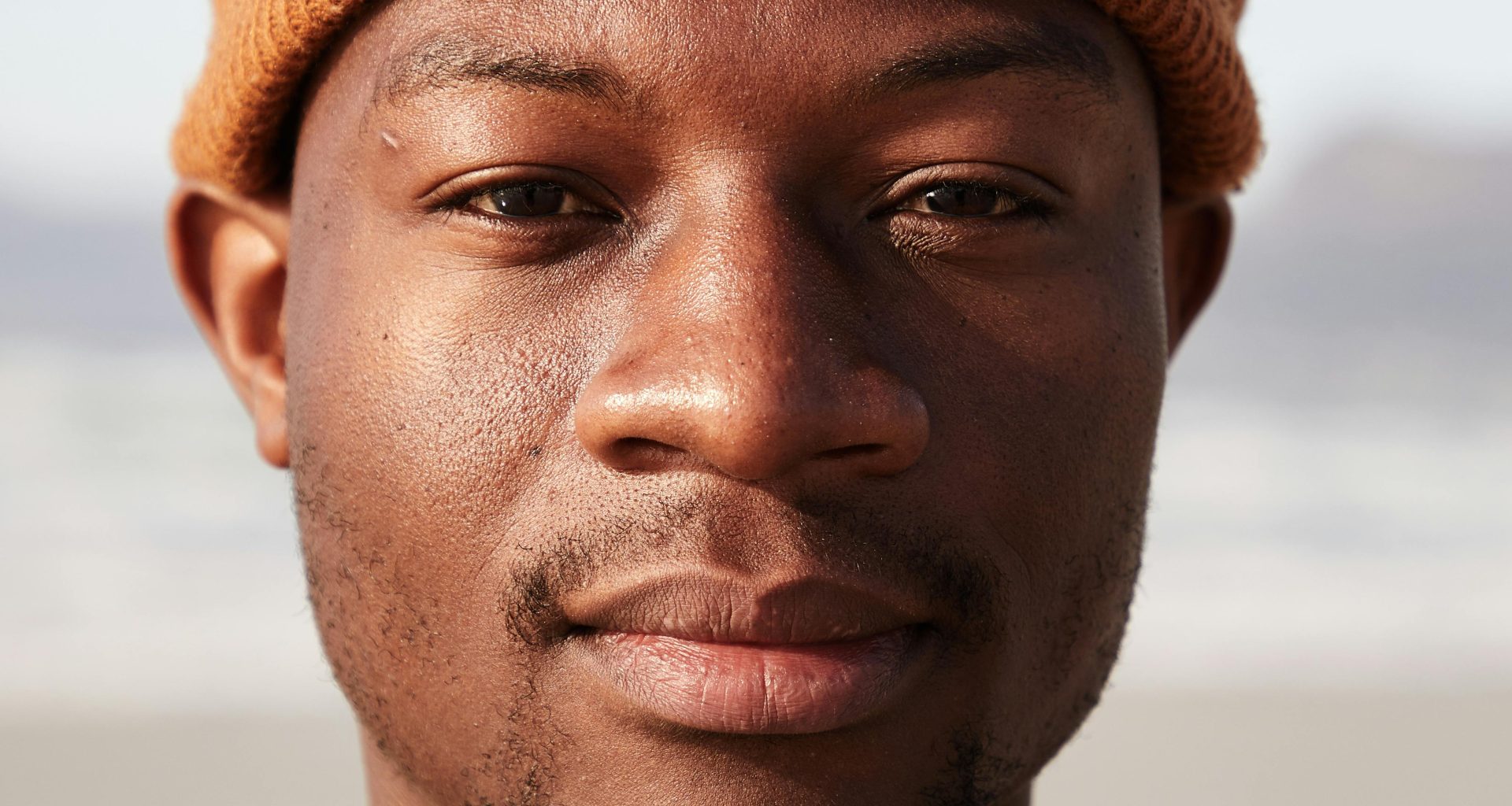 man with beanie staring into camera