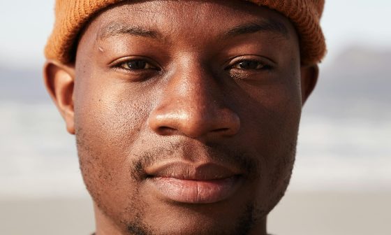 man with beanie staring into camera