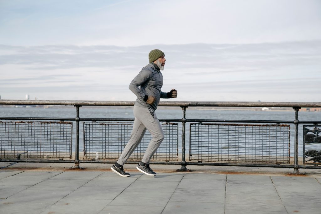 man running by water