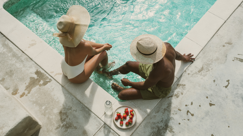two people sitting by a pool