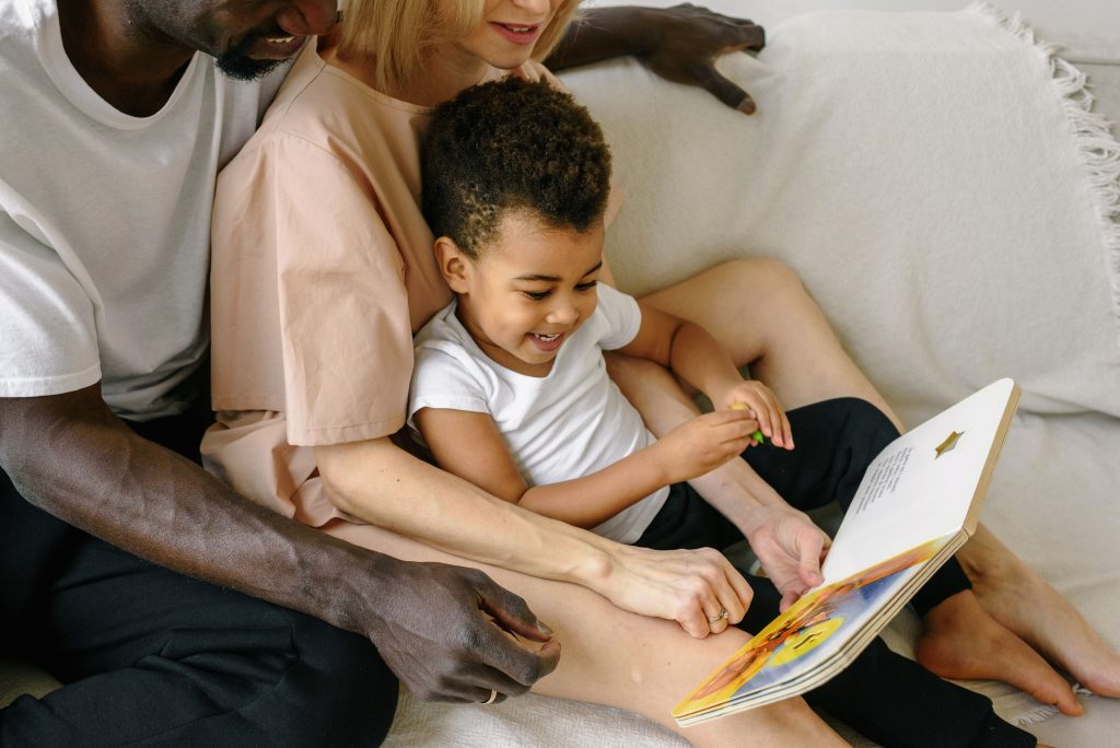 parents reading their child a book